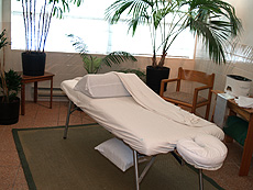 [Open area view of massage treatment room]